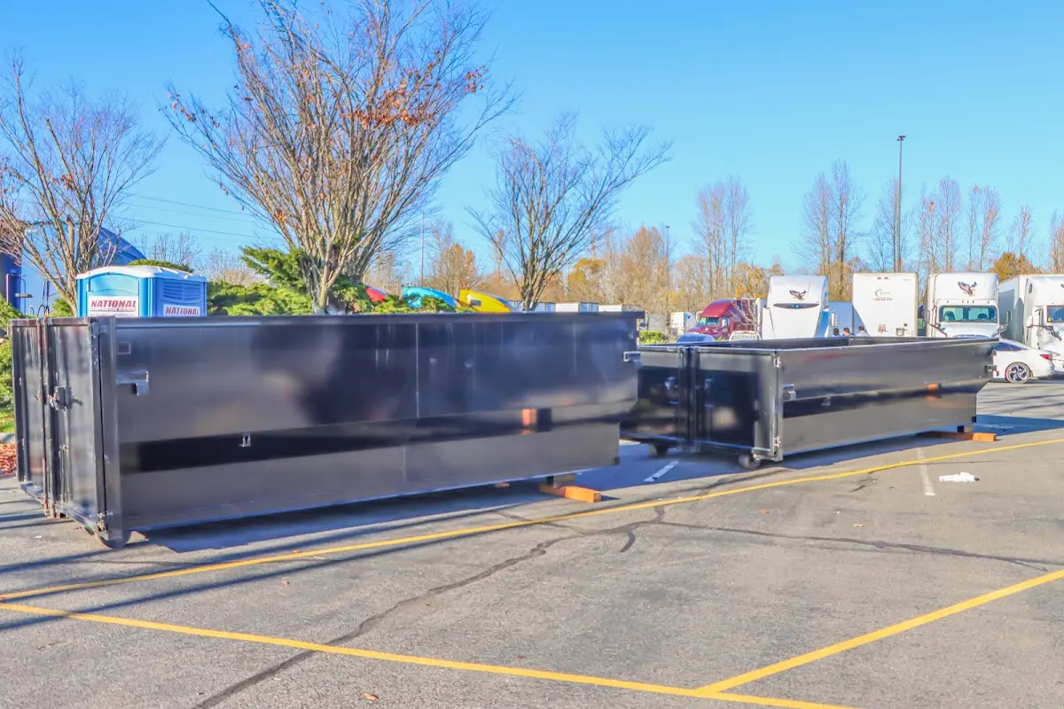 Professional dumpster rental service with roll-off container on residential driveway in Orange